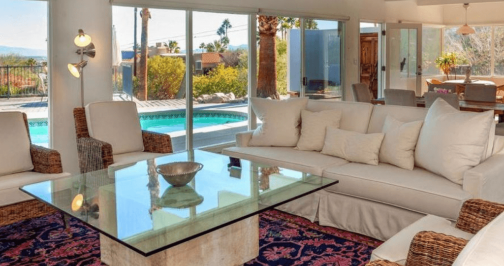 Hilltop Holiday Home interior. Living and dining room overlooking the pool and Palm Springs.